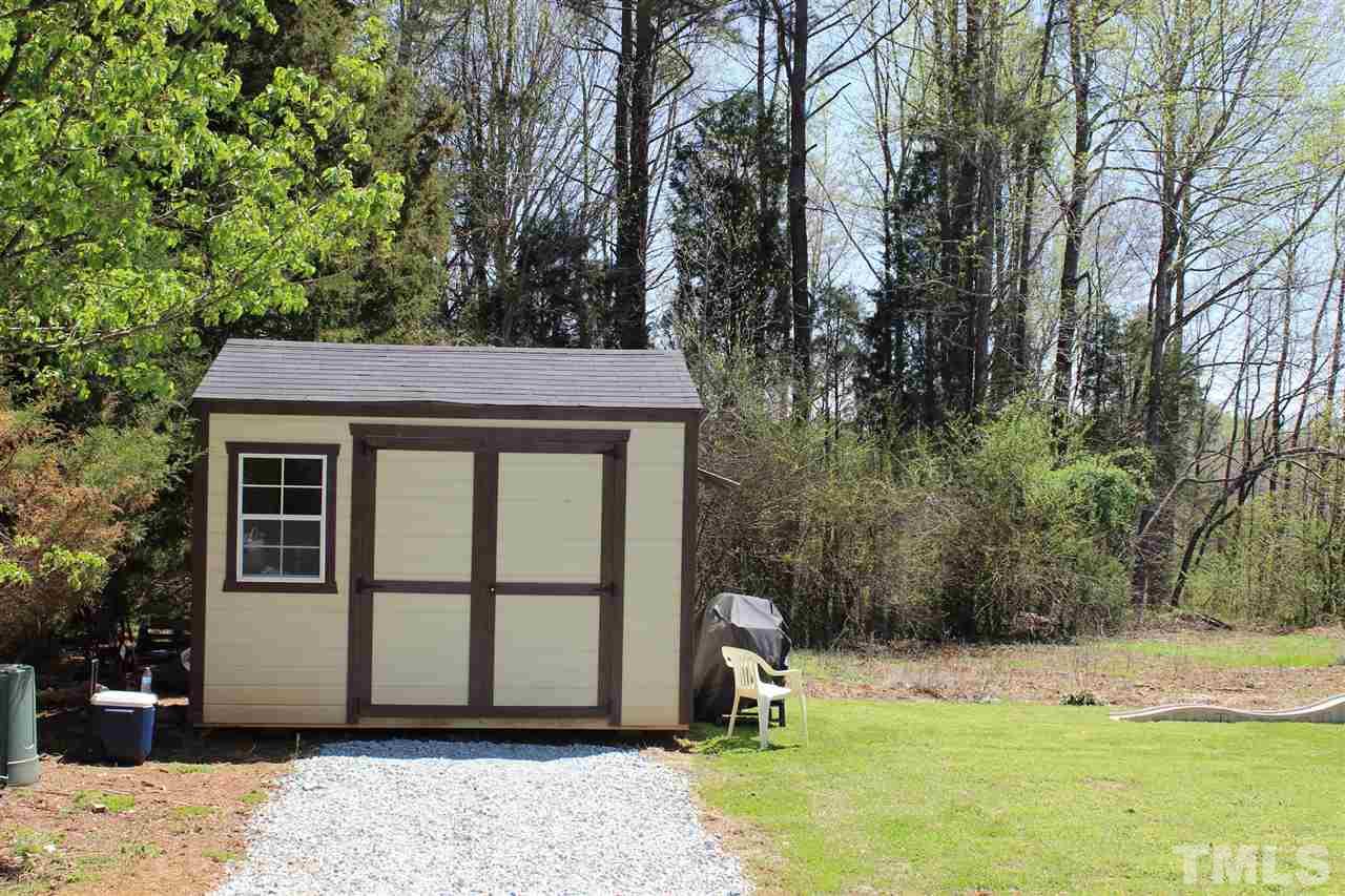 462 Pixley Pritchard Road Timberlake, NC 27583 - Photo 25 of 25 a view of a backyard with a large tree