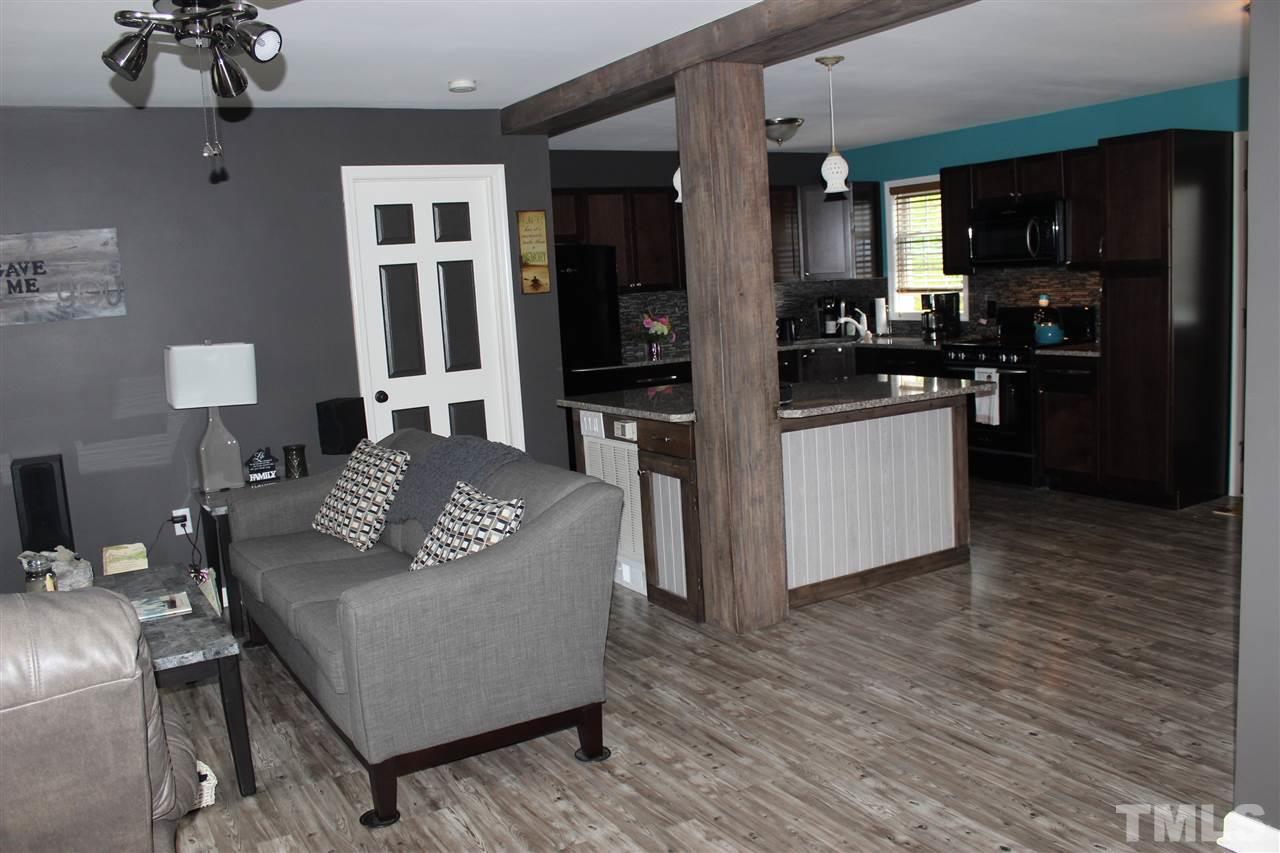 462 Pixley Pritchard Road Timberlake, NC 27583 - Photo 8 of 25 a living room with furniture and a wooden floor