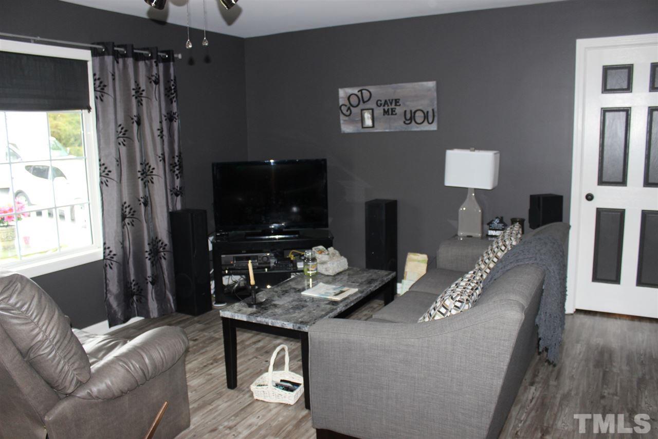 462 Pixley Pritchard Road Timberlake, NC 27583 - Photo 9 of 25 a living room with furniture and a flat screen tv