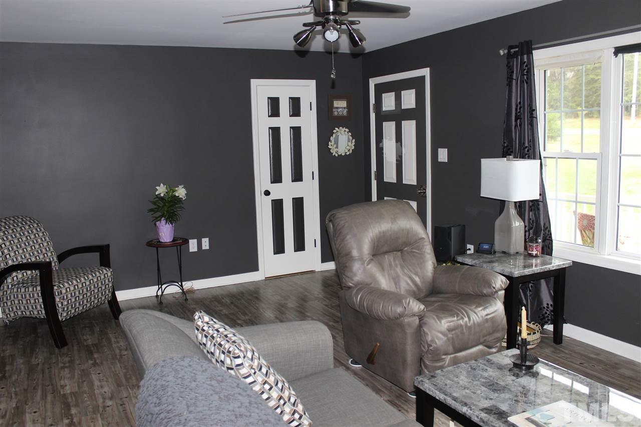 462 Pixley Pritchard Road Timberlake, NC 27583 - Photo 10 of 25 a living room with furniture and a chandelier