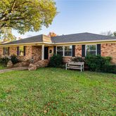 a front view of house with yard and outdoor seating