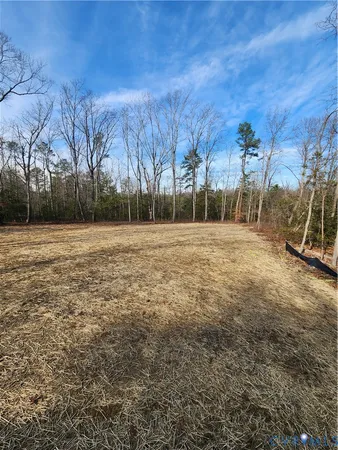 an empty room with closet and entryway