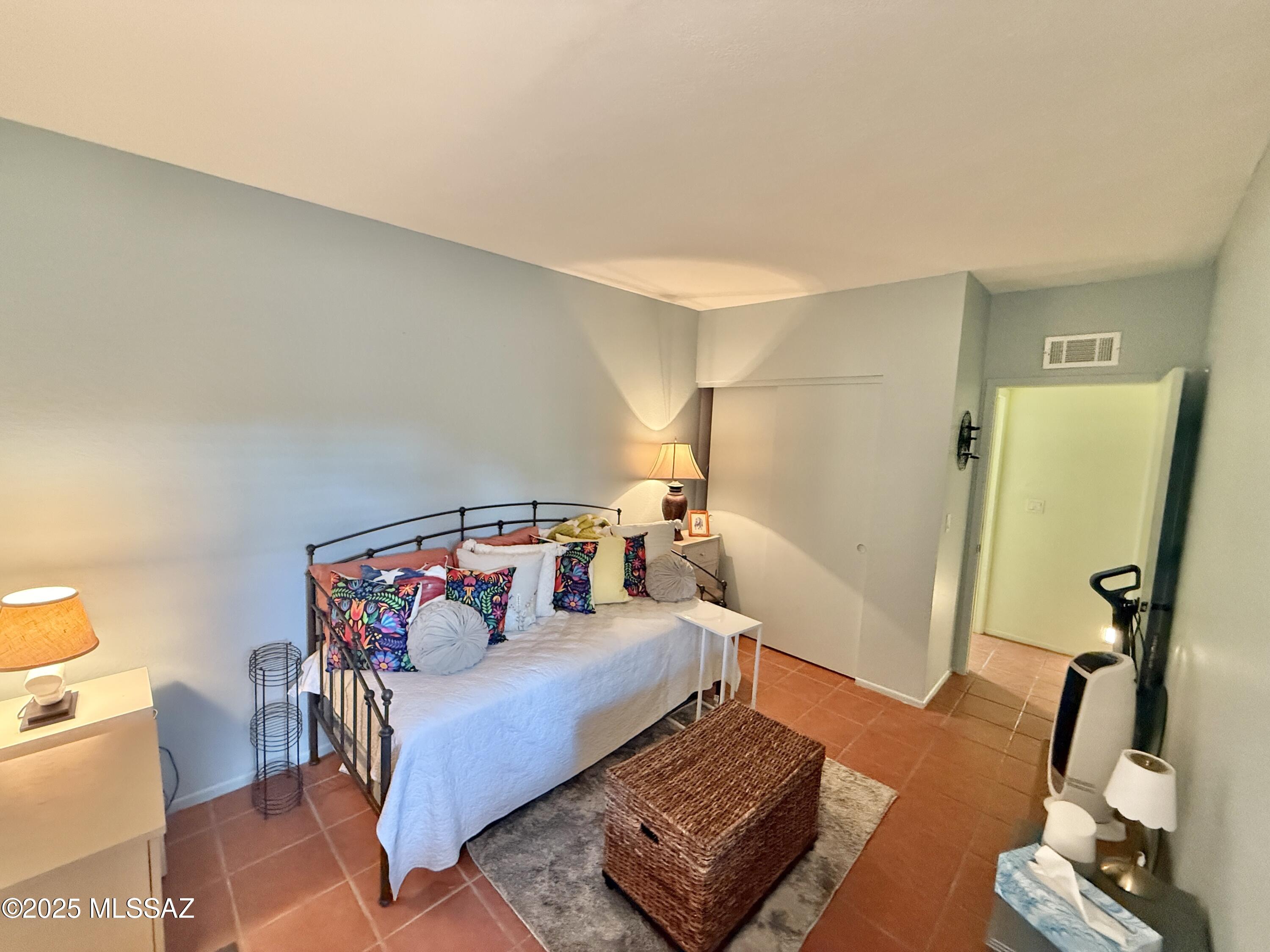 8110 East Rivenoak Circle Tucson, AZ 85715 - Photo 19 of 29 a bedroom with furniture and a wooden floor