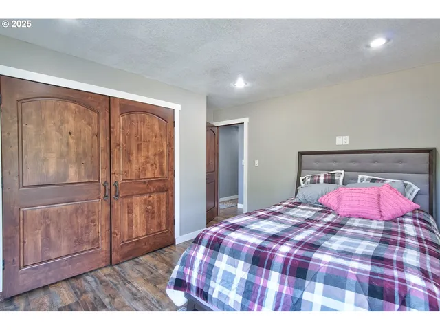 a bedroom with a bed and a dresser