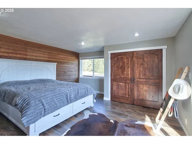 a living room with a bed furniture and next to a window