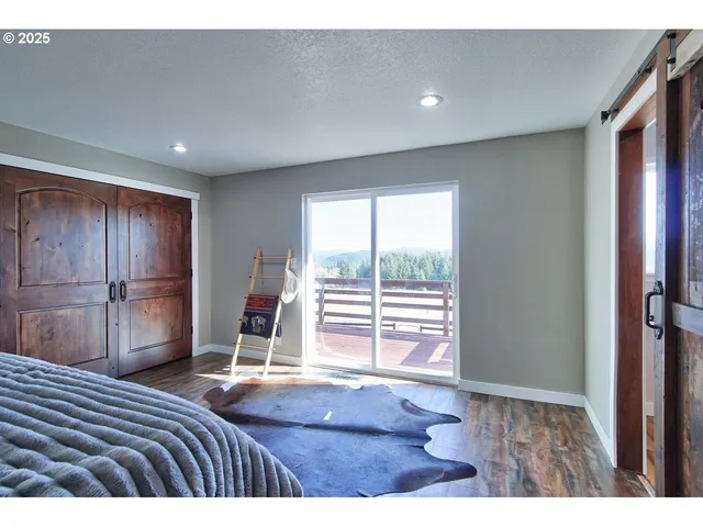 a bedroom with a bed and a large window