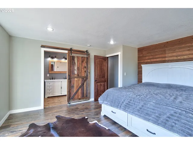 a spacious bedroom with a bed and walk in closet