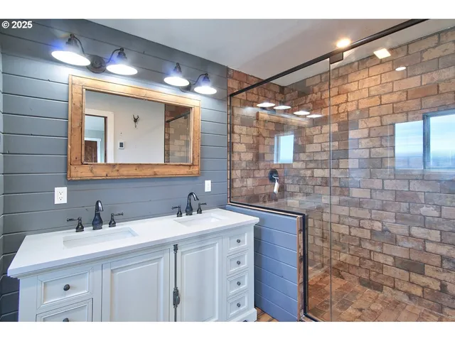 a bathroom with a sink vanity and mirror