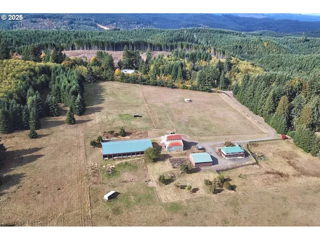 an aerial view of a house with a yard basket ball court and outdoor seating
