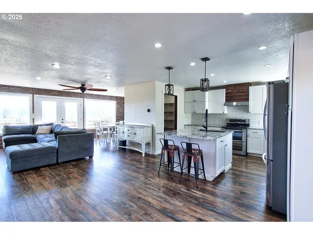 a living room with furniture and kitchen view