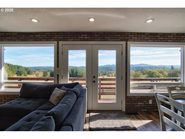 a living room with furniture and a floor to ceiling window