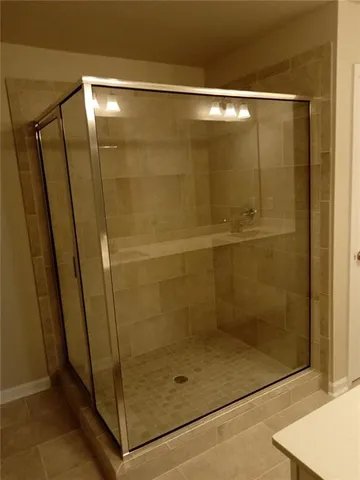 a bathroom with a glass shower door