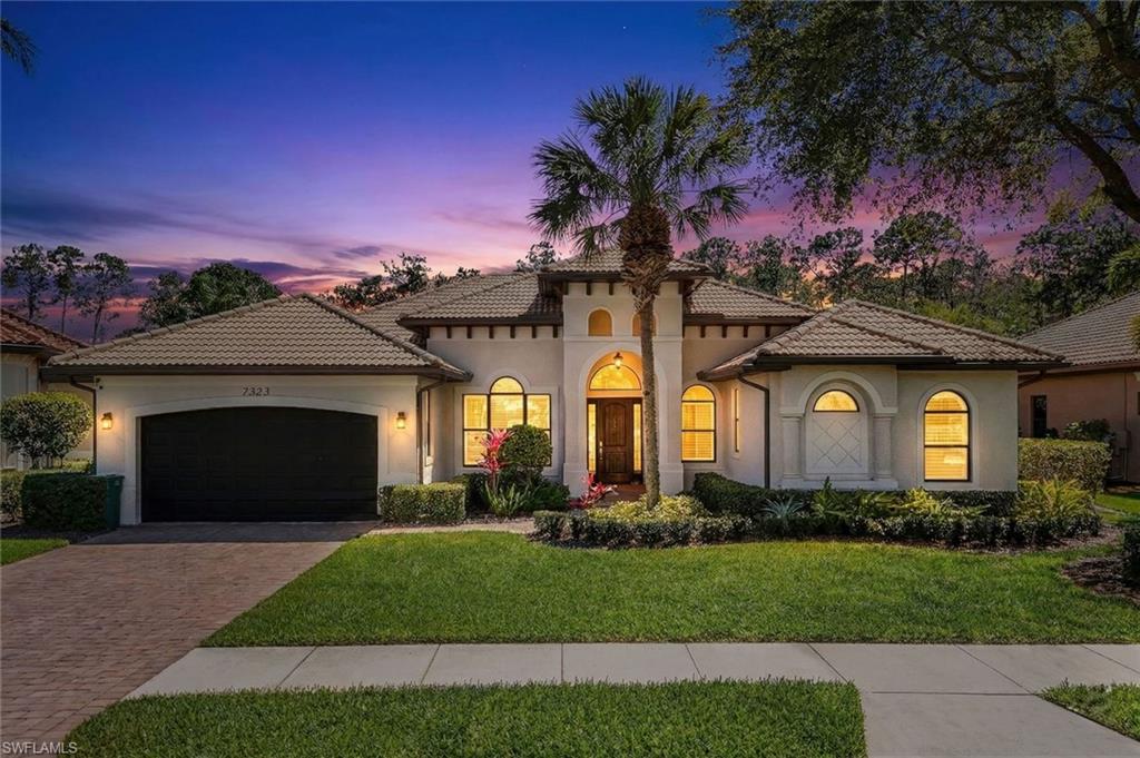 Mediterranean / spanish house featuring stucco siding, a garage, decorative driveway, a tile roof, and a front lawn
