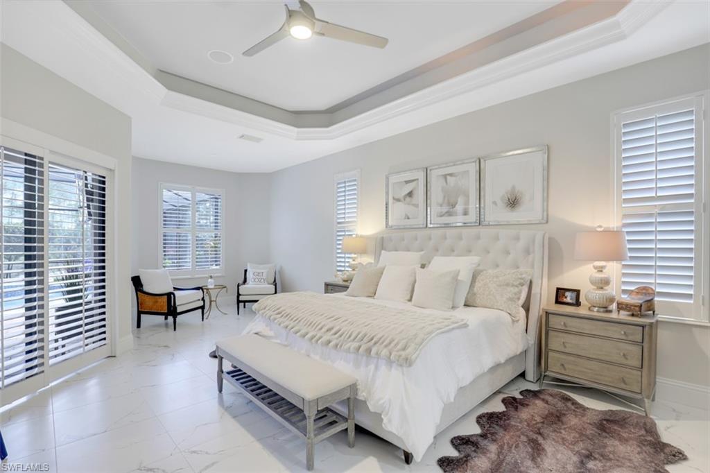 7323 Acorn Way Naples, FL 34119 - Photo 14 of 28 Bedroom with a raised ceiling, access to outside, ceiling fan, tile flooring, and crown molding