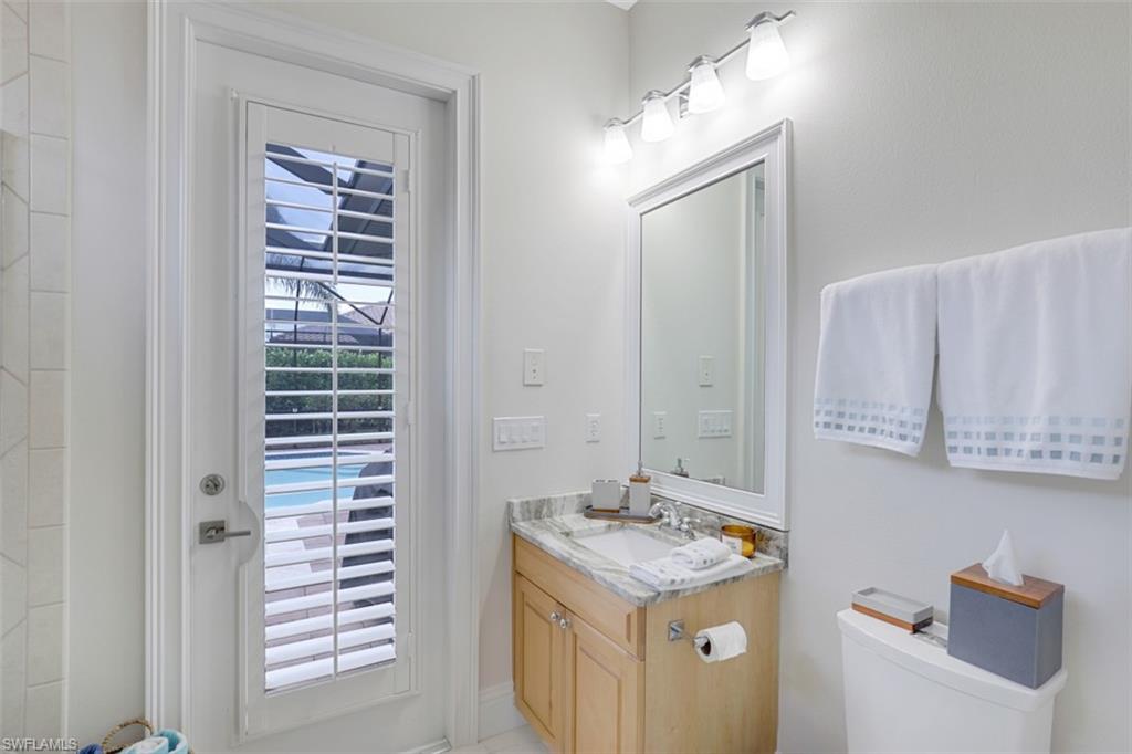 7323 Acorn Way Naples, FL 34119 - Photo 21 of 28 3rd pool bath with vanity, toilet and shower