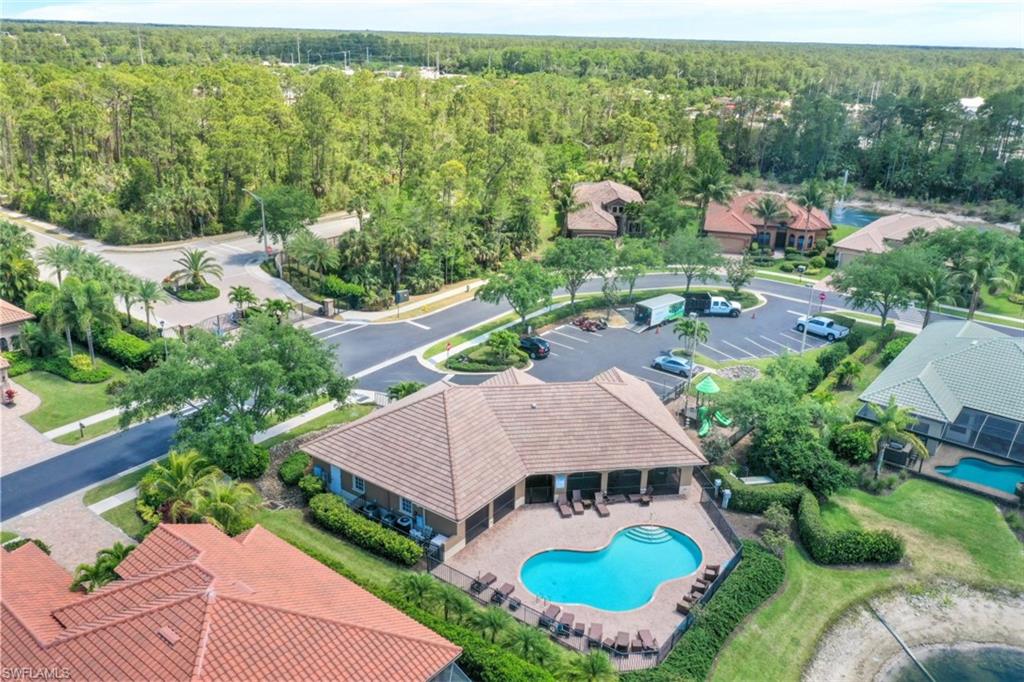 7323 Acorn Way Naples, FL 34119 - Photo 25 of 28 Aerial view of Clubhouse with community pool and workout facility
