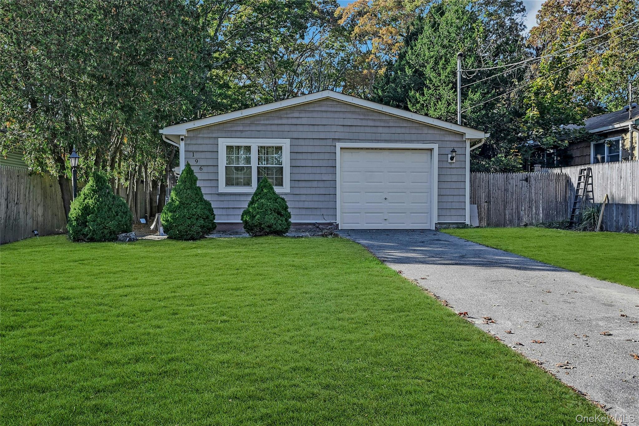 196 Church Drive Mastic Beach, NY 11951 - Photo 1 of 15 a view of a yard in front of a house with plants and large tree