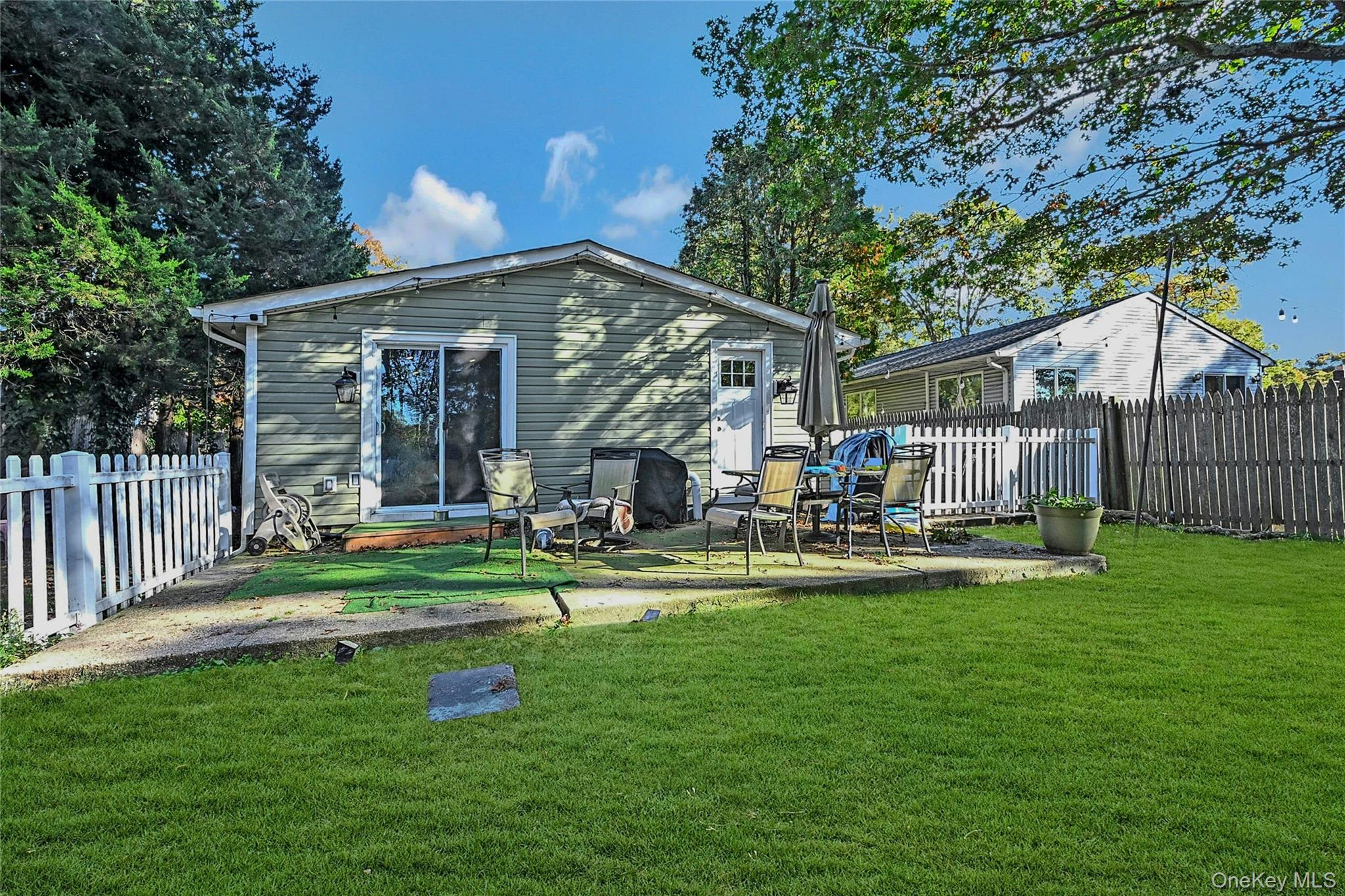 196 Church Drive Mastic Beach, NY 11951 - Photo 13 of 15 a house view with a sitting space and garden