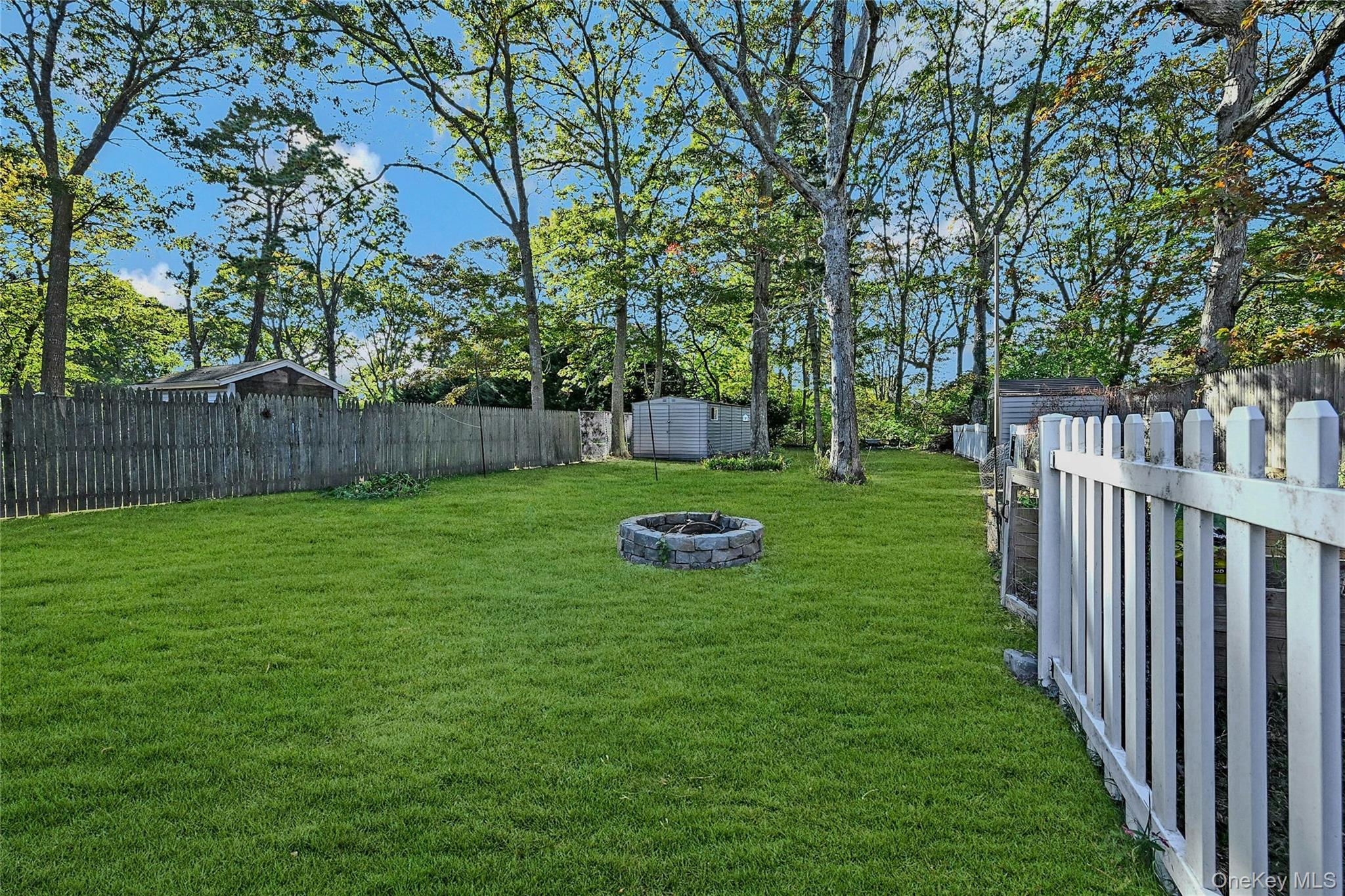 196 Church Drive Mastic Beach, NY 11951 - Photo 14 of 15 a view of a backyard with large trees
