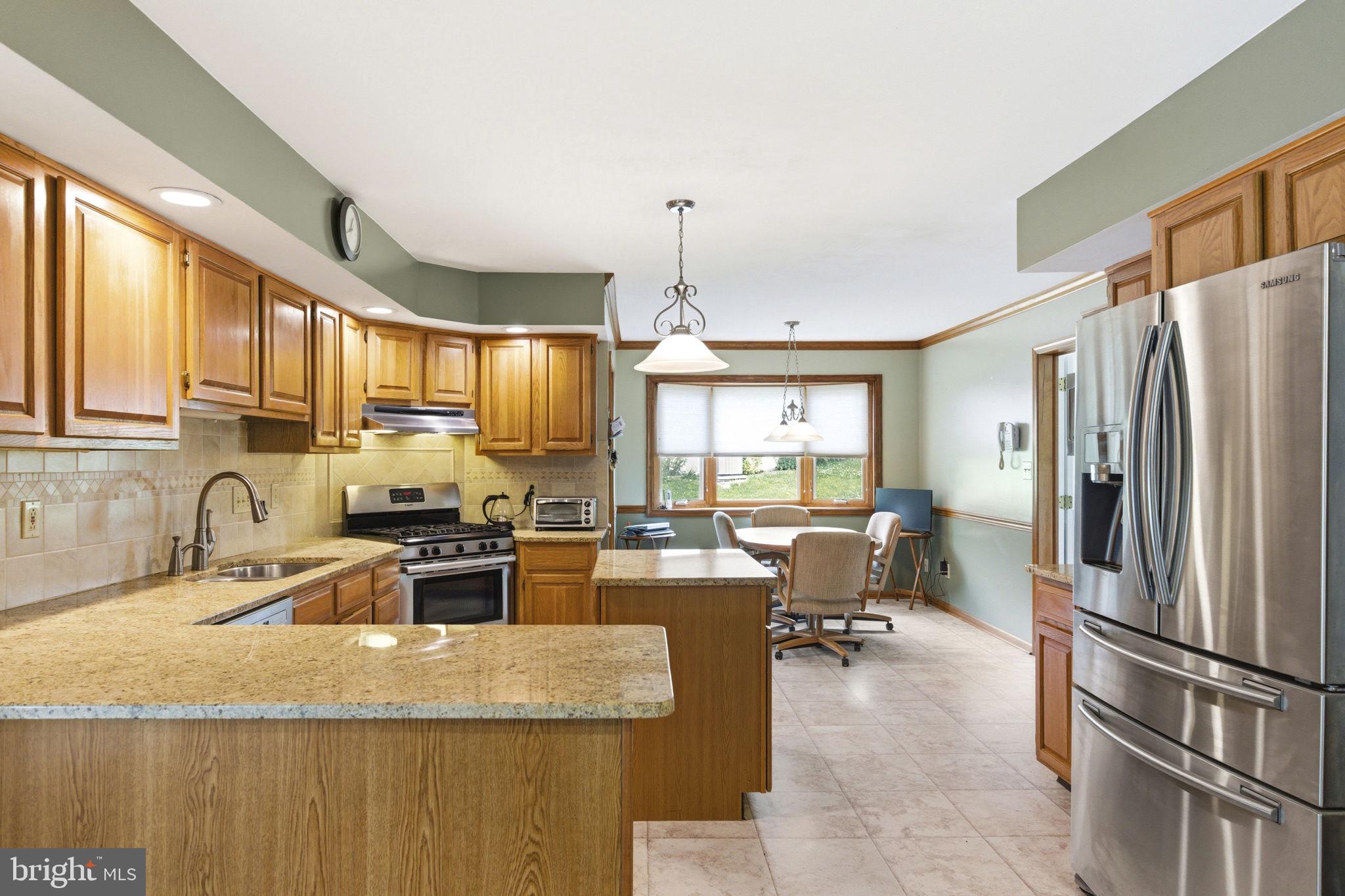 736 Letitia Drive Hockessin, DE 19707 - Photo 39 of 92 a kitchen with kitchen island a large counter top space appliances and a window