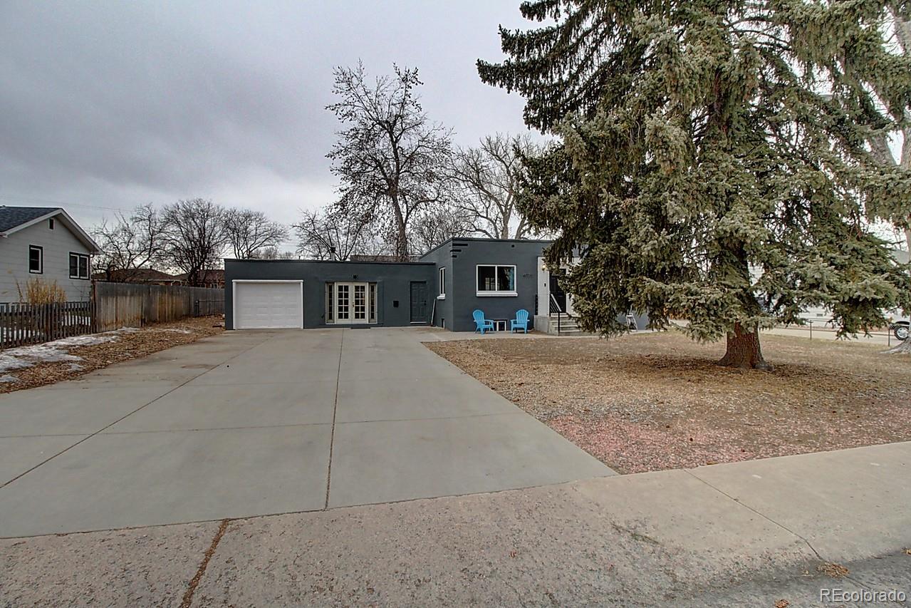 4075 Quay Street Wheat Ridge, CO 80033 - Photo 1 of 38 a front view of a house with a yard and garage