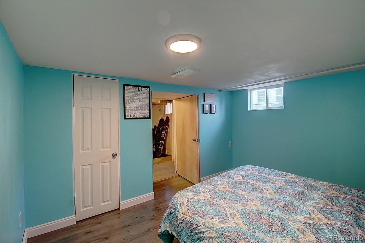 4075 Quay Street Wheat Ridge, CO 80033 - Photo 11 of 38 a bedroom with a bed and a window