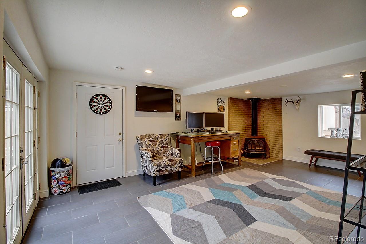 4075 Quay Street Wheat Ridge, CO 80033 - Photo 12 of 38 a living room with furniture and a flat screen tv