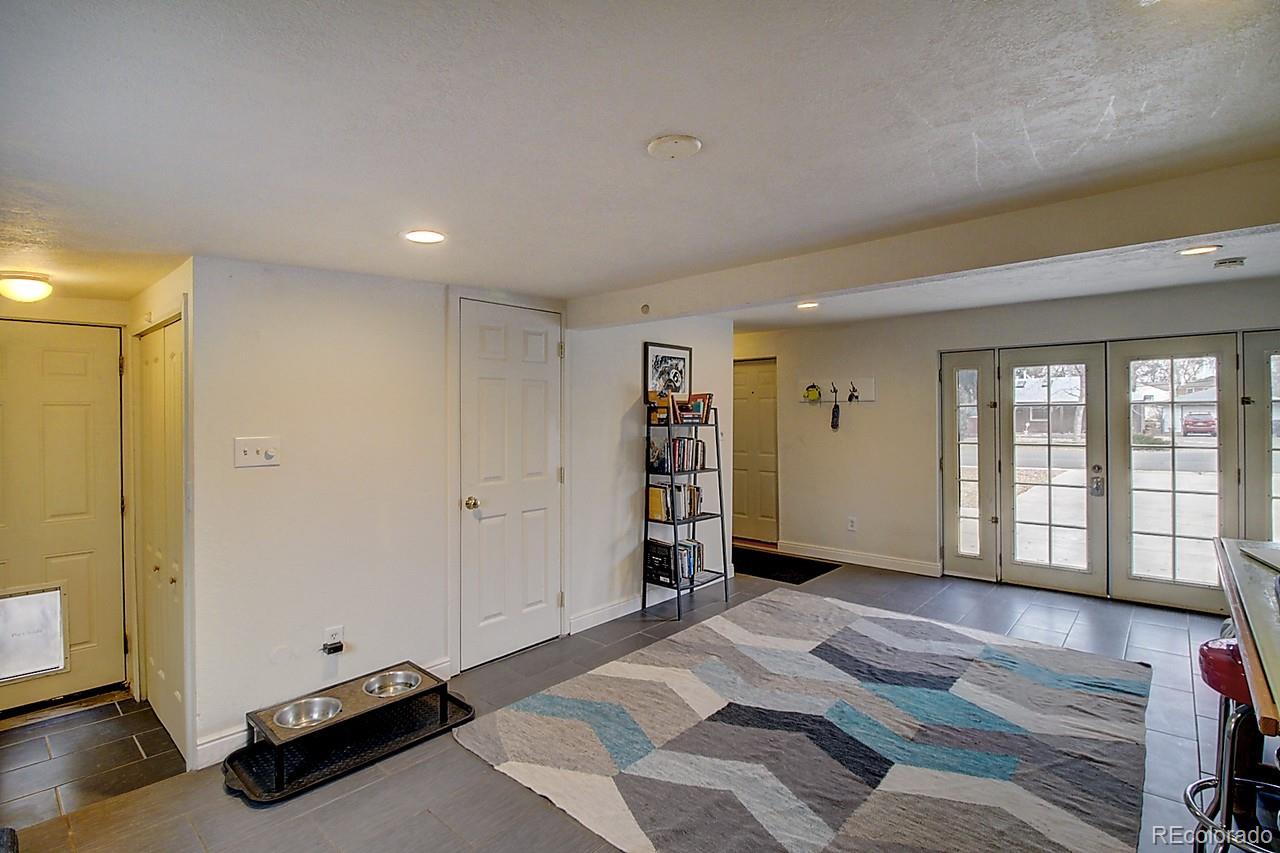 4075 Quay Street Wheat Ridge, CO 80033 - Photo 15 of 38 a spacious bedroom with a bed and a window