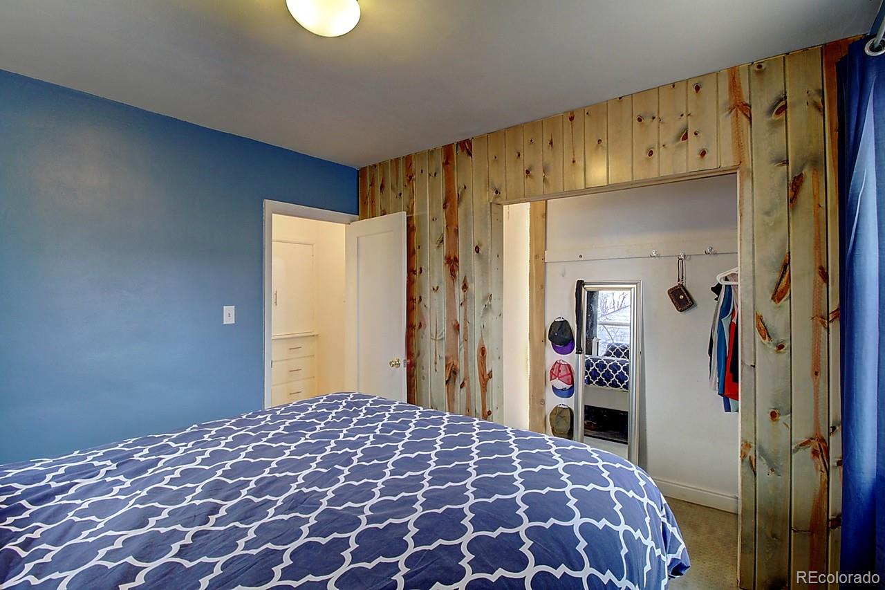 4075 Quay Street Wheat Ridge, CO 80033 - Photo 16 of 38 a bedroom with a large bed and a closet