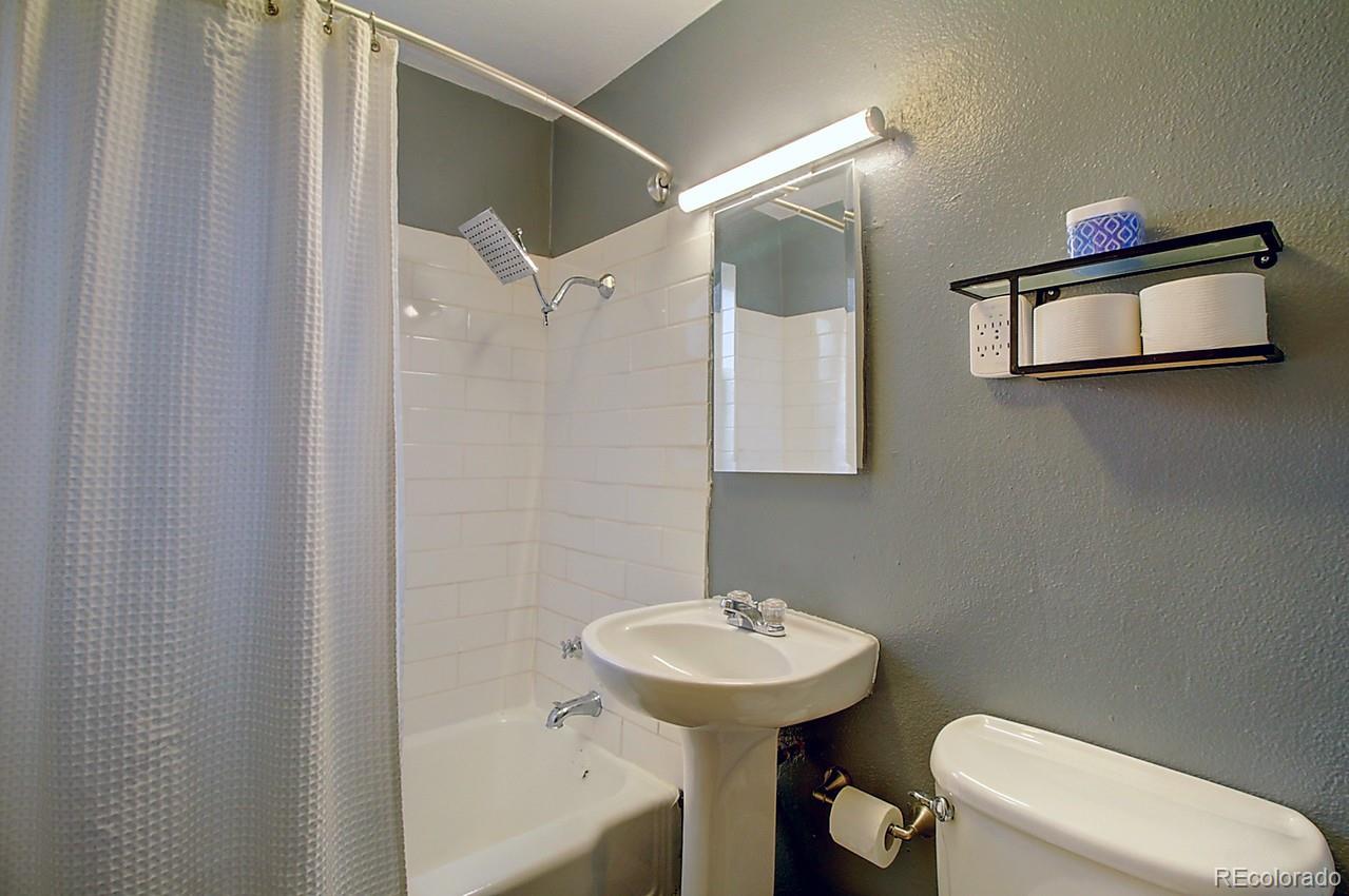 4075 Quay Street Wheat Ridge, CO 80033 - Photo 19 of 38 a bathroom with a sink a toilet and shower
