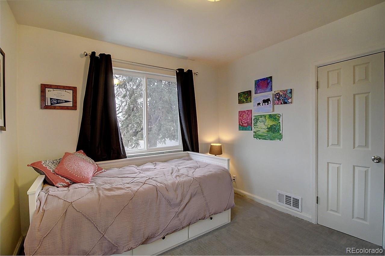 4075 Quay Street Wheat Ridge, CO 80033 - Photo 21 of 38 a bedroom with a bed and a flat tv screen