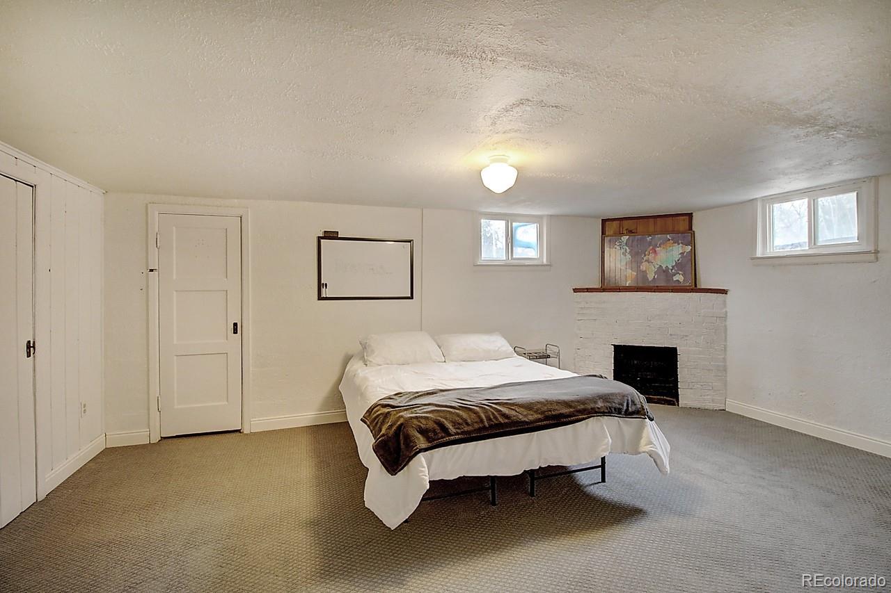4075 Quay Street Wheat Ridge, CO 80033 - Photo 23 of 38 a bedroom with a bed and a fireplace