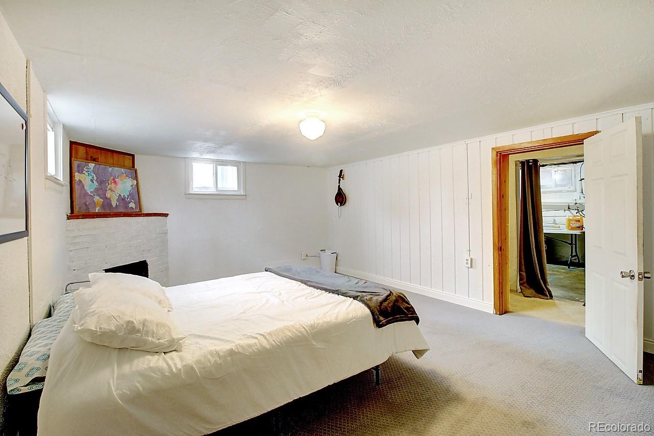 4075 Quay Street Wheat Ridge, CO 80033 - Photo 24 of 38 a bedroom with a bed and a painting on the wall