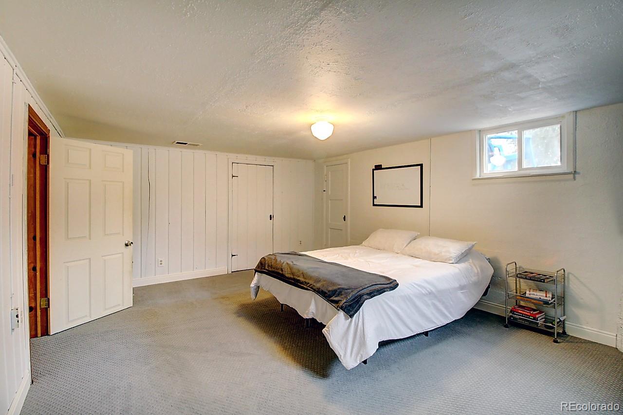 4075 Quay Street Wheat Ridge, CO 80033 - Photo 25 of 38 a spacious bedroom with a bed and a window