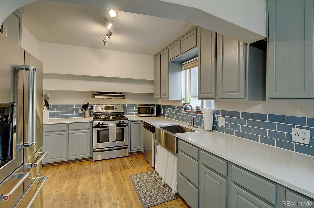4075 Quay Street Wheat Ridge, CO 80033 - Photo 26 of 38 a kitchen with a sink a stove and refrigerator