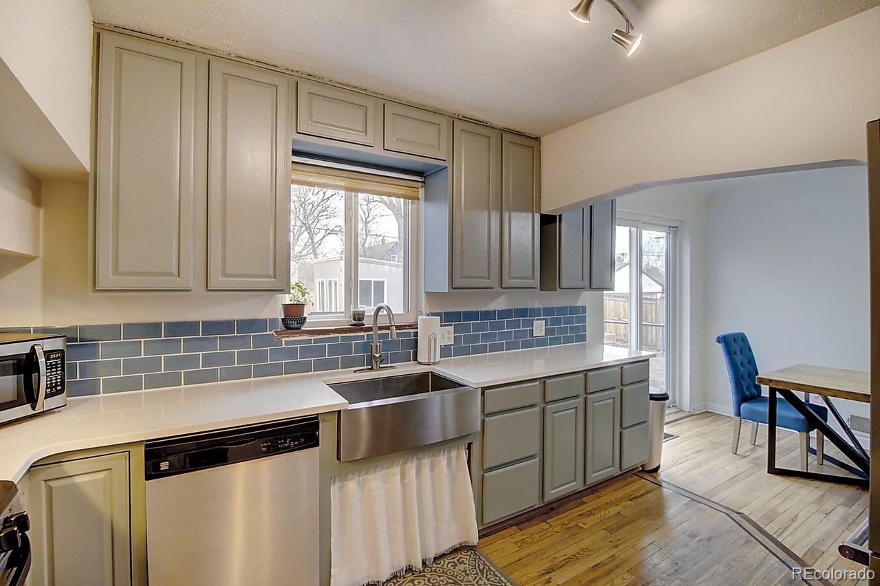 4075 Quay Street Wheat Ridge, CO 80033 - Photo 27 of 38 a kitchen with stainless steel appliances granite countertop a sink stove and cabinets
