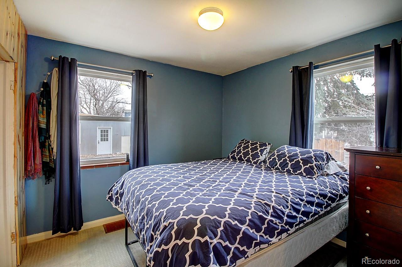 4075 Quay Street Wheat Ridge, CO 80033 - Photo 29 of 38 a bedroom with a large bed and a window