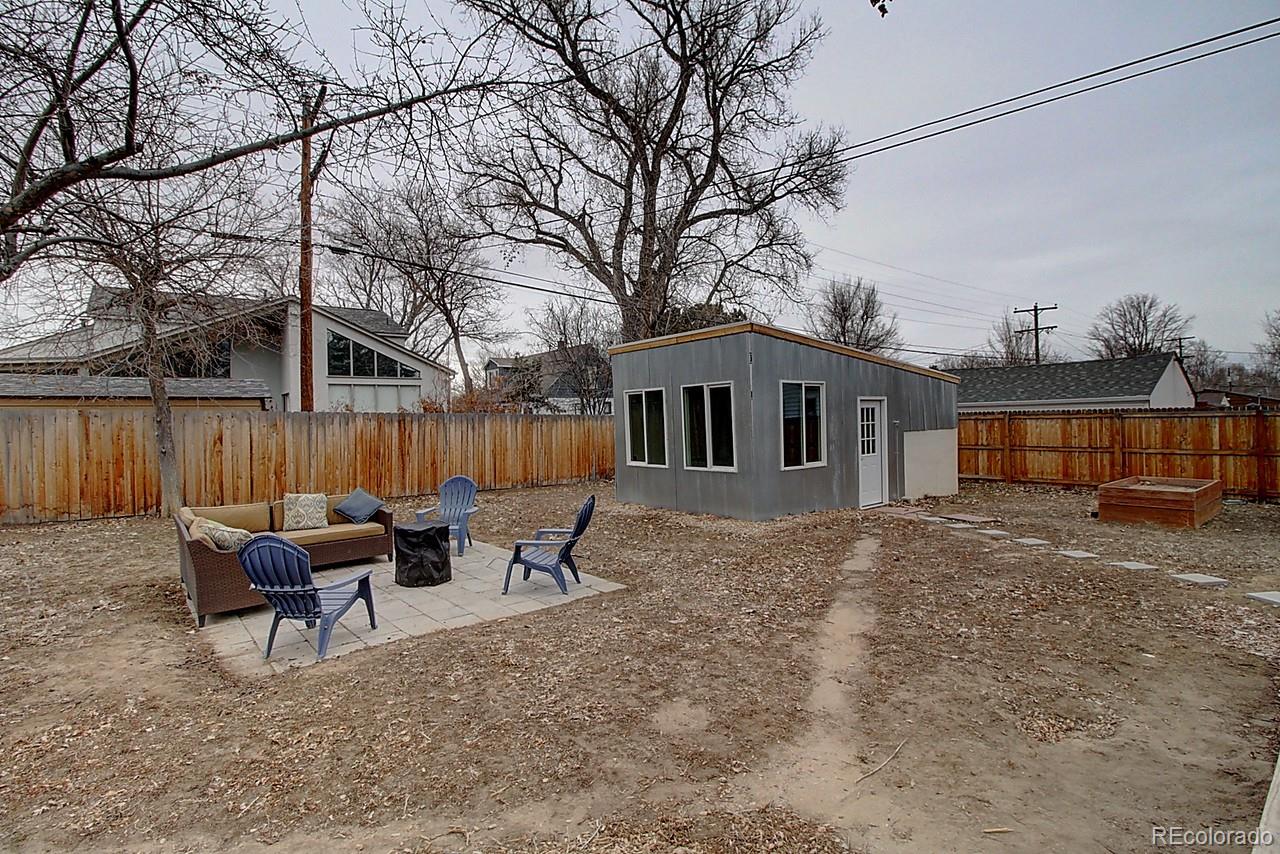 4075 Quay Street Wheat Ridge, CO 80033 - Photo 38 of 38 a backyard of a house with table and chairs