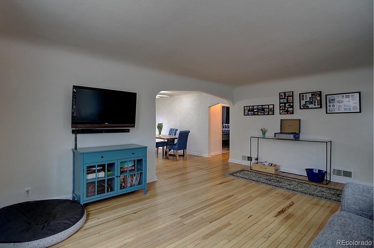 4075 Quay Street Wheat Ridge, CO 80033 - Photo 4 of 38 a living room with furniture and a flat screen tv
