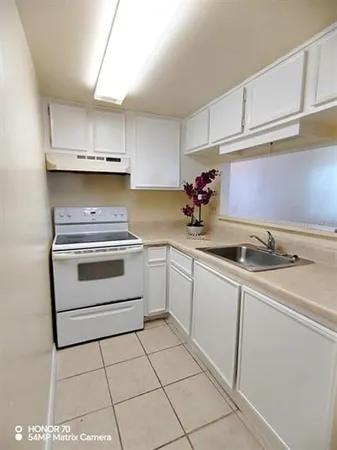 a view of a room with an empty space and a window