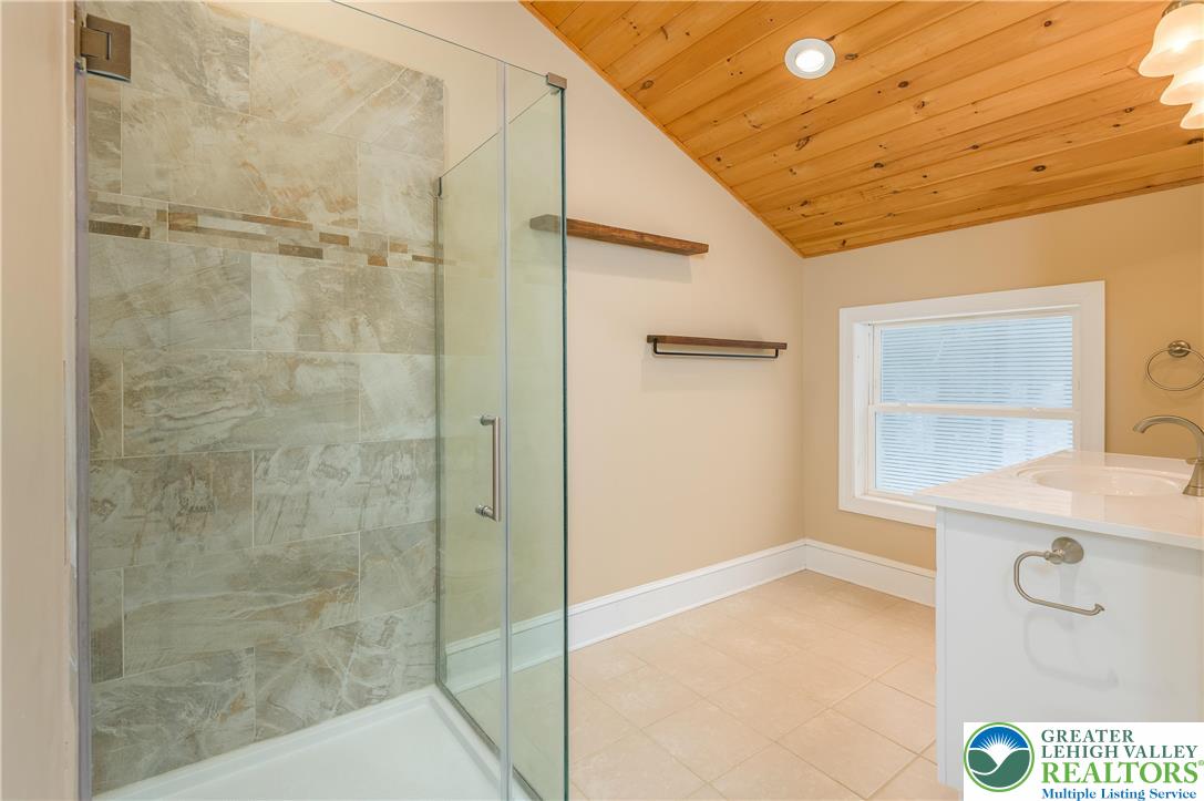 169 Shiny Mountain Road Greentown, PA 18426 - Photo 21 of 54 a bathroom with a granite countertop sink a mirror and a shower