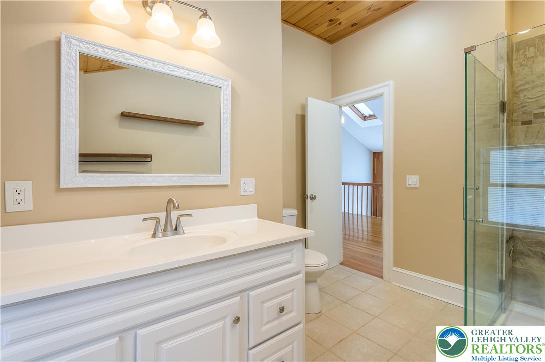 169 Shiny Mountain Road Greentown, PA 18426 - Photo 22 of 54 a bathroom with a sink a shower and a mirror