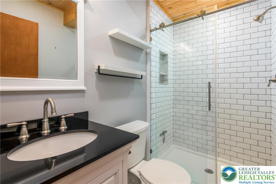 169 Shiny Mountain Road Greentown, PA 18426 - Photo 34 of 54 a bathroom with a granite countertop toilet sink and mirror