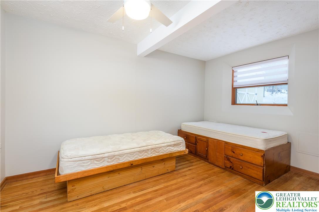 169 Shiny Mountain Road Greentown, PA 18426 - Photo 35 of 54 a bedroom with a bed and a night stand
