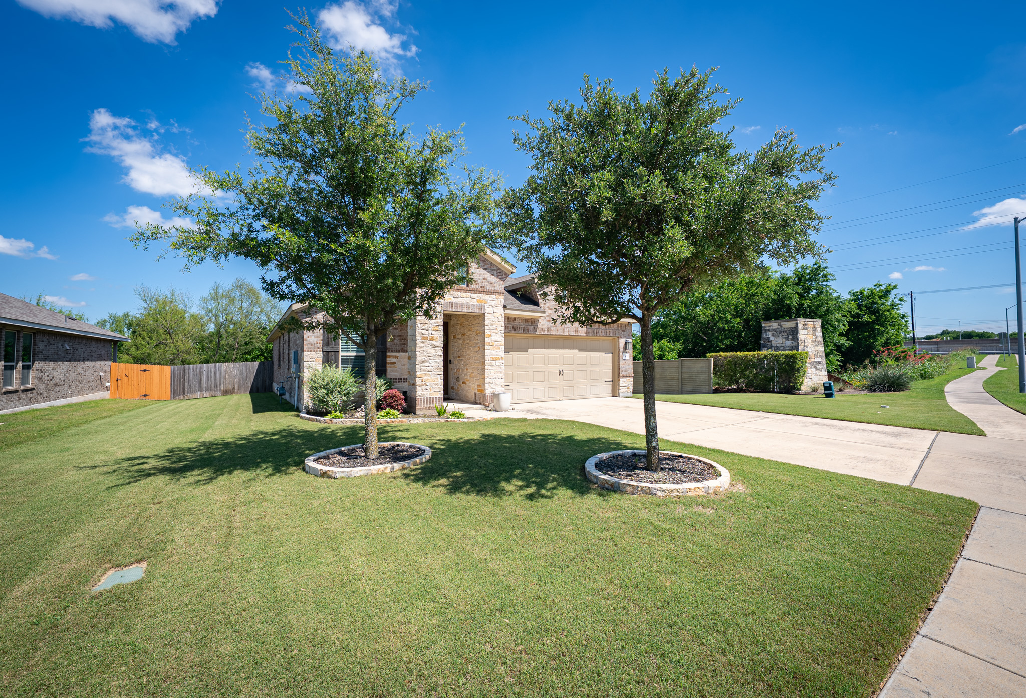 2508 Hat Bender Loop Round Rock, TX 78664 - Photo 3 of 22 Stone and brick facade residence with a two-car garage