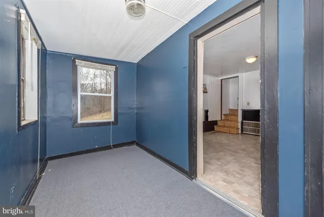 an empty room that has a window and a livingroom view