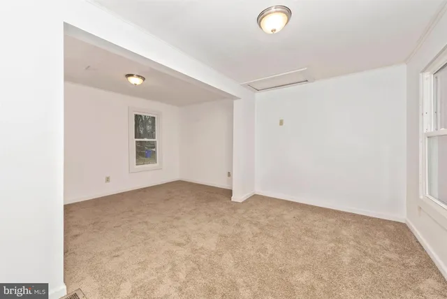 a view of a house with a wooden fence