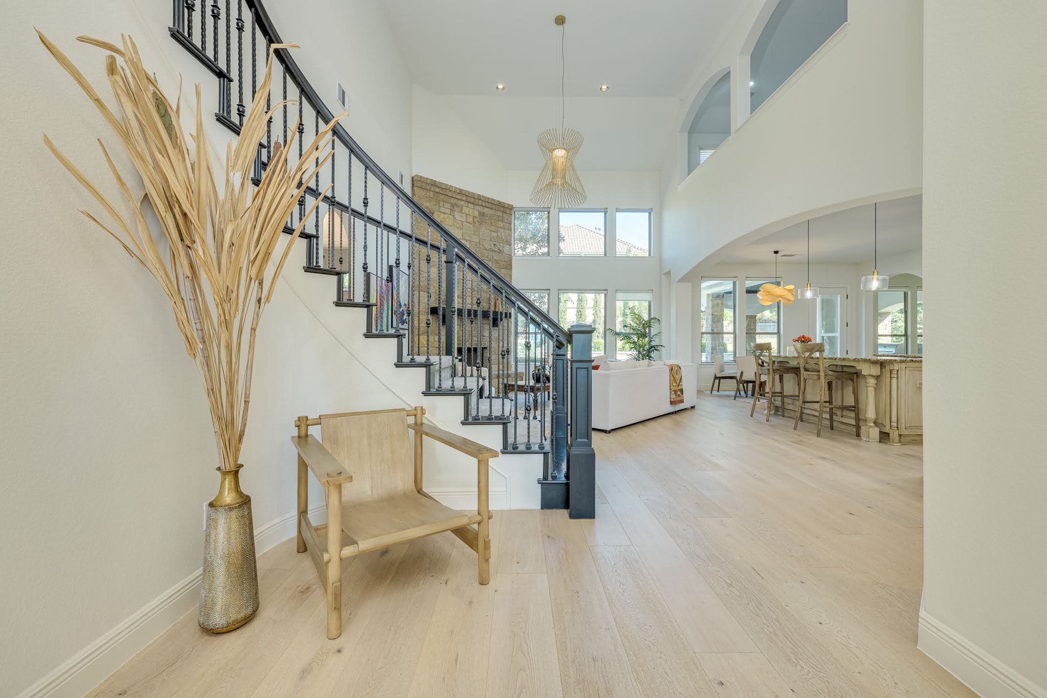 11612 Shoreview Overlook Austin, TX 78732 - Photo 7 of 40 Gleaming hardwood floors run throughout the soaring, open entryway featuring an elegant staircase.