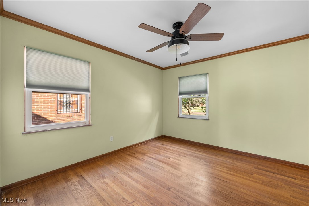 18122 Nottingham Road Cleveland, OH 44119 - Photo 12 of 29 Bedroom featuring crown molding, wood finished floors, and a ceiling fan