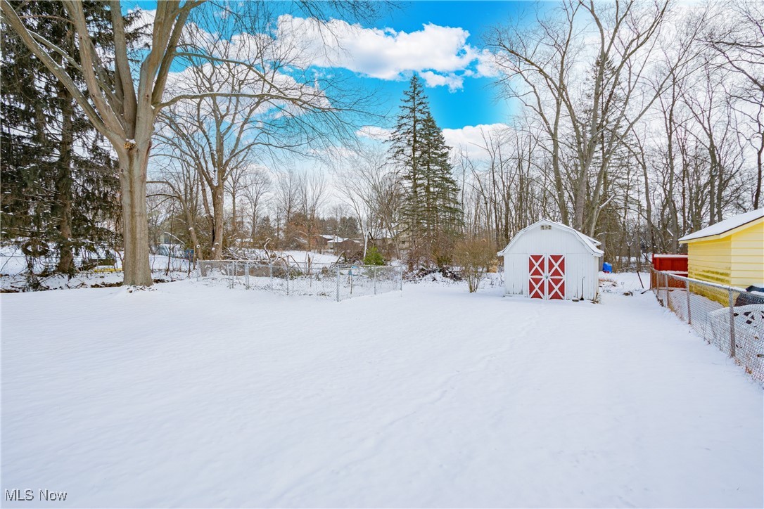 5905 Renninger Road New Franklin, OH 44319 - Photo 28 of 31 Yard layered in snow featuring an outdoor structure